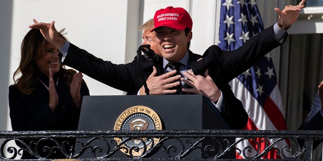 First lady Melania Trump laughs as President Trump hugs Washington Nationals catcher Kurt Suzuki during an event to honor the 2019 World Series Champion, Washington Nationals, at the White House, Monday, Nov. 4, 2019, in Washington. (AP Photo/ Evan Vucci)