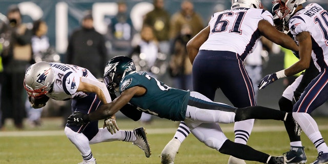 New England Patriots' Rex Burkhead (34) is tackled by Philadelphia Eagles' Malcolm Jenkins (27) during the first half of an NFL football game, Sunday, Nov. 17, 2019, in Philadelphia. (AP Photo/Michael Perez)