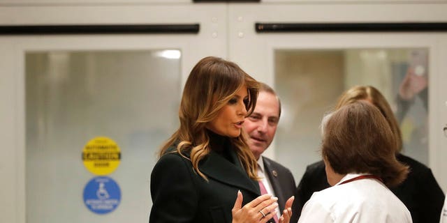 First lady Melania Trump, left, speak with pediatrician Eileen Costello, front right, as U.S. Secretary of Health and Human Services Alex Azar, behind center, looks on during a visit to Boston Medical Center, in Boston, Wednesday, Nov. 6, 2019. (AP Photo/Steven Senne, Pool)