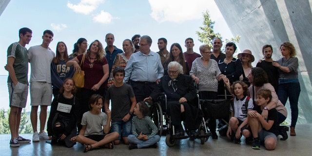Melpomeni Dina, center right, posing for a group photo during the reunion at the Yad Vashem Holocaust memorial in Jerusalem.