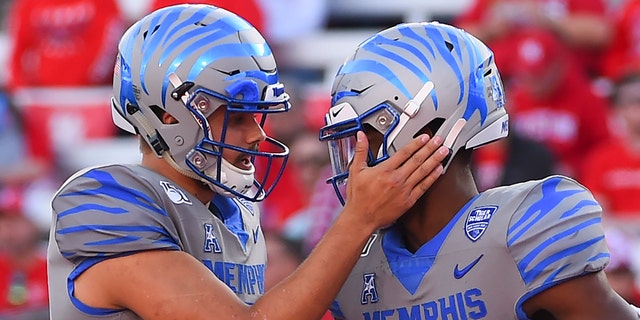 Memphis wide receiver Damonte Coxie, right, celebrates his touchdown with quarterback Brady White during the first half of an NCAA college football game against Houston, Saturday, Nov. 16, 2019, in Houston. (AP Photo/Eric Christian Smith)