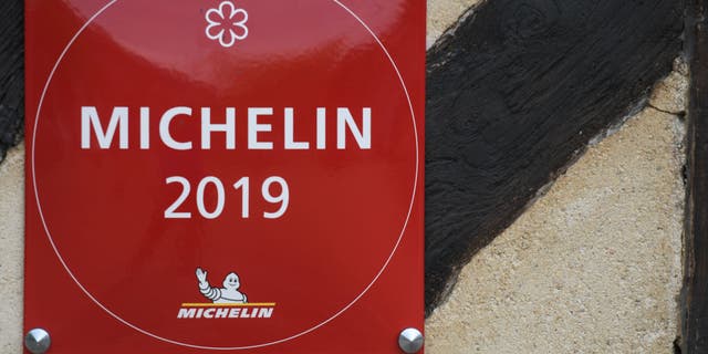 Inclusion in the Michelin Guide is often touted by restaurateurs — such as the restaurant seen debuting a 'Michelin 2019' sign in France, seen here — but Eo Yun-gwon calls the guide subjective, and claims he has repeatedly asked to be left off the list.
