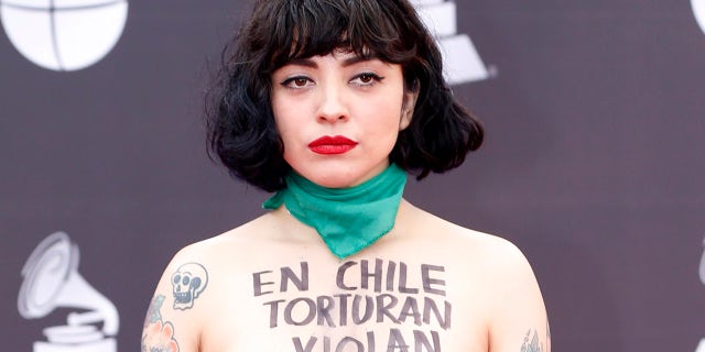 Mon Laferte arrives at the 20th Latin Grammy Awards with "En Chile torturan violan y matan" written on her body on Thursday, Nov. 14, 2019, at the MGM Grand Garden Arena in Las Vegas. (Photo by Eric Jamison/Invision/AP)