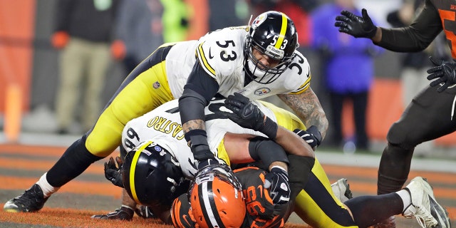 Cleveland Browns defensive end Myles Garrett (95) is punched by Pittsburgh Steelers center Maurkice Pouncey (53) and tackled by offensive guard David DeCastro (66) during the second half of an NFL football game Thursday, Nov. 14, 2019, in Cleveland. The Browns won 21-7. (AP Photo/Ron Schwane)