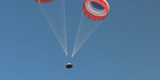 The parachutes deploy on the Starliner capsule. (Image credit: NASA TV)