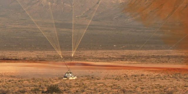 The Starliner capsule lands in the New Mexico desert. (Image credit: NASA TV)