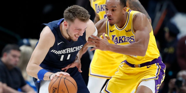 Dallas Mavericks' Luka Doncic, left, works against Los Angeles Lakers' Avery Bradley during the first half of an NBA basketball game in Dallas, Friday, Nov. 1, 2019. (AP Photo/Tony Gutierrez)