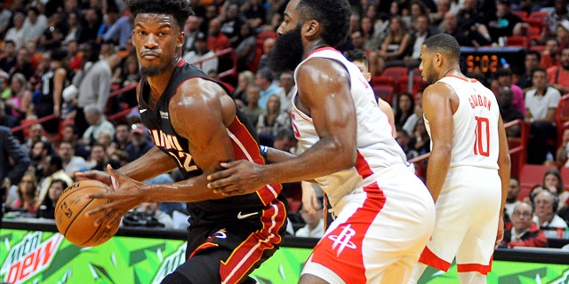 Miami Heat guard Jimmy Butler, left, drives against Houston Rockets guard James Harden during the first half of an NBA basketball game, Sunday, Nov. 3, 2019, in Miami. (AP Photo/Gaston De Cardenas)