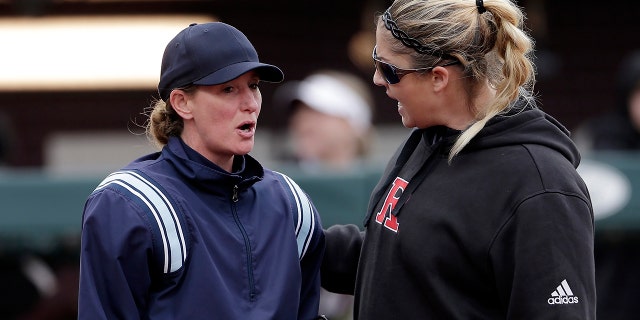 Rutgers head coach Kristen Butler, right, argues a call with the home plate umpire during an NCAA softball game against Texas A&M in College Station, Texas, on Feb. 16, 2019.