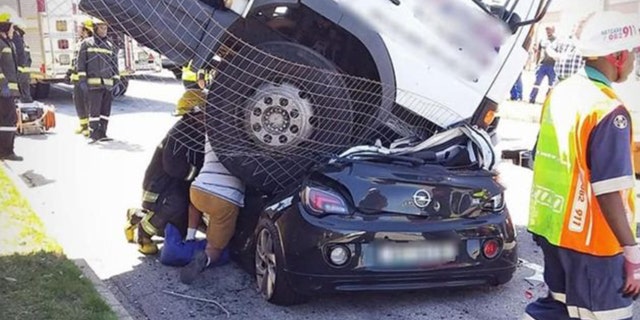 Authorities said the woman was trapped inside her car for nearly 40 minutes as rescuers worked to free her.