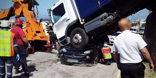 A 26-year-old woman suffered serious injuries after a truck landed on top of her car in South Africa on Tuesday.