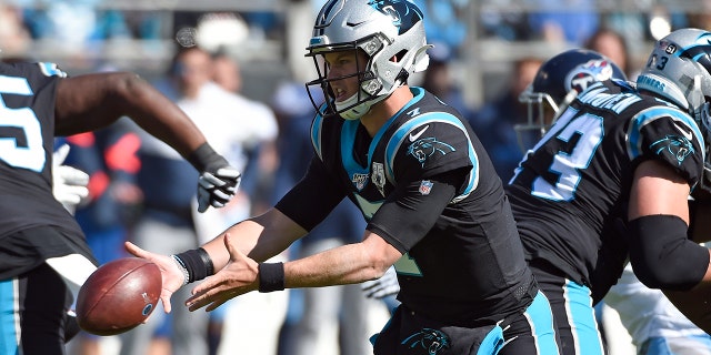 Carolina Panthers quarterback Kyle Allen tosses the ball during the first half of an NFL football game against the Tennessee Titans in Charlotte, N.C., Sunday, Nov. 3, 2019. (AP Photo/Mike McCarn)