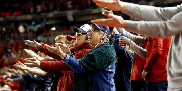 Fns gesture the baby shark as Washington Nationals' Gerardo Parra bats during the sixth inning of Game 3 of the baseball World Series against the Houston Astros, in Washington, on Oct. 25, 2019. (AP Photo/Patrick Semansky, File)