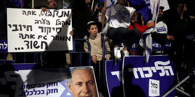 Netanyahu supporters demonstrate outside his home following his indictment last week.