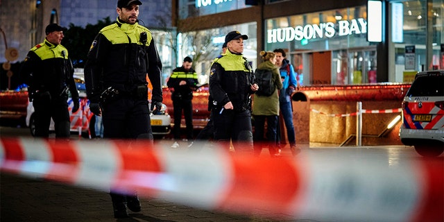 Dutch police secure a shopping street after a stabbing incident in the center of The Hague, Netherlands, Friday, Nov. 29, 2019. Dutch police say multiple people have been injured in a stabbing incident in The Hague's main shopping street. (AP Photo/Phil Nijhuis)