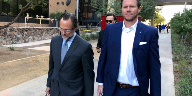 Maricopa County Assessor Paul Petersen, right, leaves his arraignment hearing with attorney Kurt Altman Tuesday. (AP Photo/Jacques Billeaud)