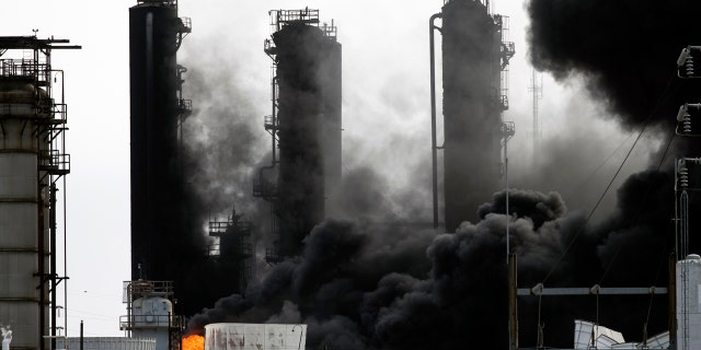 Smoke and fire are visible from the TPC Group Port Neches Operations explosion on Wednesday. (Marie D. De Jesus /Houston Chronicle via AP)
