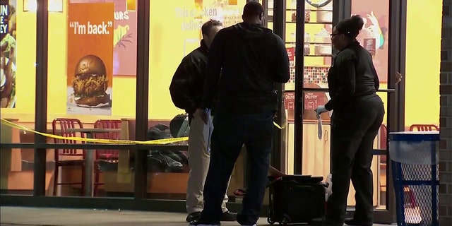 Investigators examine the scene in Oxon Hill Monday night.