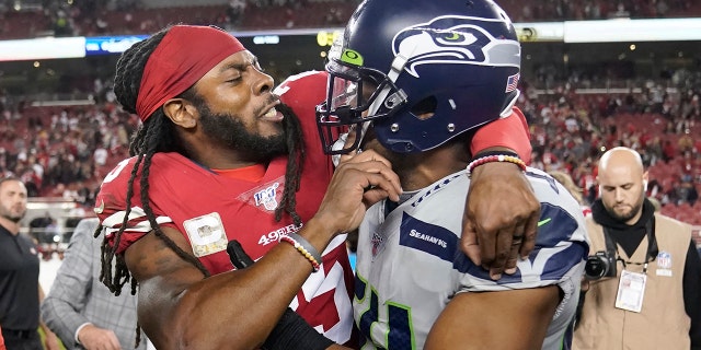 San Francisco 49ers cornerback Richard Sherman, left, hugs Seattle Seahawks middle linebacker Bobby Wagner after an NFL football game in Santa Clara, Calif., Monday, Nov. 11, 2019. The Seahawks won 27-24 in overtime.