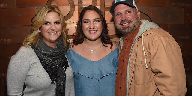 Singer/songwriter Allie Colleen Brooks, center, daughter of Garth Brooks and first wife Sandy Brooks poses with her stepmom singer/songwriter Trisha Yearwood and dad singer/songwriter Garth Brooks after making her Grand Ole Opry debut during Dr. Ralph Stanley Forever.