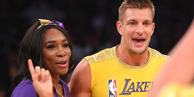Venus Williams and Rob Gronkowski laugh after participating with the Los Angeles Lakers girls during halftime of the game against the Oklahoma City Thunder at Staples Center on Nov. 19, 2019, in Los Angeles. (Jayne Kamin-Oncea-USA TODAY Sports)