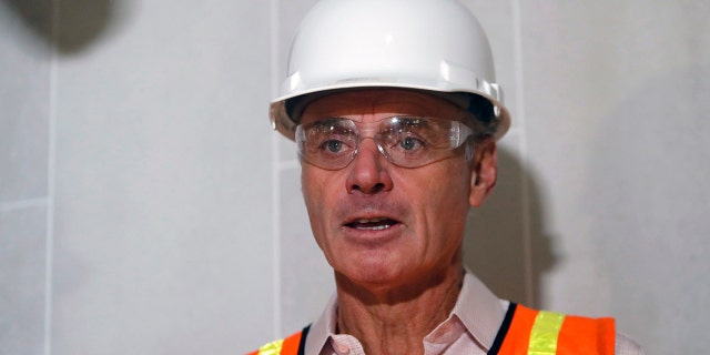Baseball Commissioner Rob Manfred speaks to the media during a tour of the new under construction Texas Rangers stadium in Arlington, Texas, Tuesday, Nov. 19, 2019. Manfred hopes the investigation into sign stealing by the Houston Astros will be completed by next season and says he has broad authority to impose discipline beyond fines, the loss of amateur draft picks and taking away international signing bonus pool allocation. (AP Photo/LM Otero)