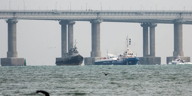 Seized Ukrainian naval ships are towed by Russia's Coast Guard vessels out of the port in Kerch, near the bridge connecting the Russian mainland with the Crimean Peninsula, Crimea Nov. 17, 2019. (REUTERS/Alla Dmitrieva)