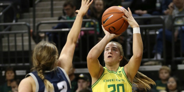 Oregon's Sabrina Ionescu, right, shots over Utah State's Taylor Franson during the second quarter of an NCAA college basketball game in Eugene, Ore., Wednesday, Nov. 13, 2019. (AP Photo/Chris Pietsch)