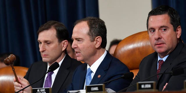 House Intelligence Committee Chairman Adam Schiff, D-Calif., center, flanked by House Democratic Counsel Daniel Goldman, left, and ranking member Devin Nunes, R-Calif., uses his gavel as former U.S. Ambassador to Ukraine Marie Yovanovitch testifies before the House Intelligence Committee on Capitol Hill in Washington, Friday, Nov. 15, 2019. (AP Photo/Susan Walsh)