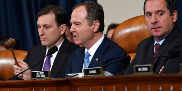 House Intelligence Committee Chairman Adam Schiff, D-Calif., center, flanked by House Democratic Counsel Daniel Goldman, left, and ranking member Devin Nunes, R-Calif., uses his gavel as former U.S. Ambassador to Ukraine Marie Yovanovitch testifies before the House Intelligence Committee on Capitol Hill in Washington, Friday, Nov. 15, 2019. (AP Photo/Susan Walsh)