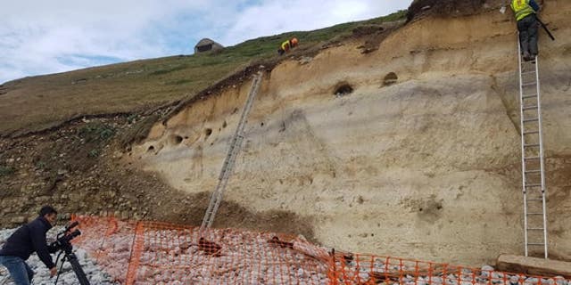 Climbing experts have helped archaeologists recover remains from the eroding cliff site.