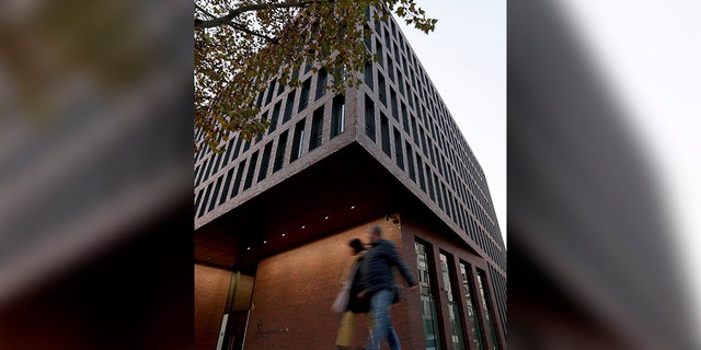 People walk past the center for advanced education (ZNAF) at the Federal Intelligence Service (BND) in Berlin Tuesday. (AP Photo/Michael Sohn)