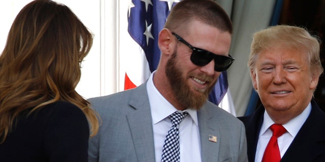 President Trump with Washington Nationals starting pitcher Stephen Strasburg at Monday's ceremony, with first lady Melania Trump nearby. (AP Photo/Patrick Semansky)