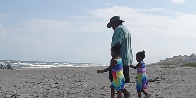 Stephone Ritchie Sr. plays with his children on Cocoa Beach before attempting to rescue his sons from a dangerous rip current.