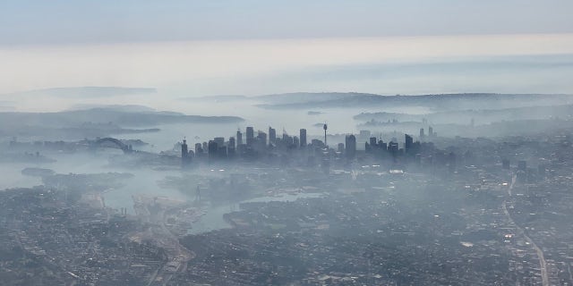 An image taken on a smartphone from a plane window shows smoke haze blanketing Sydney on, November 19, 2019.