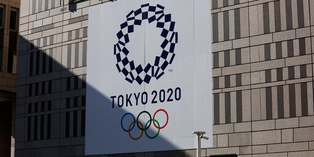 A man walks past a large Tokyo 2020 banner hanging on the facade of the Tokyo Metropolitan Government building Thursday, Nov. 21, 2019, in Tokyo. The French language has been almost invisible during the drawn-out preparations for next year’s Tokyo Olympics.(AP Photo/Jae C. Hong)