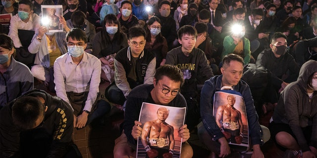 Pro-democracy protesters hold posters of US President Donald Trump during a Thanksgiving Day rally at Edinburgh Place on November 28, 2019 in Hong Kong, China. 