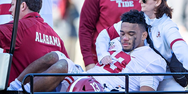 Tua Tagovailoa #13 of the Alabama Crimson Tide is helped off the field after being injured on a play in the first half of a game against the Mississippi State Bulldogs at Davis Wade Stadium on November 16, 2019 in Starkville, Mississippi. 