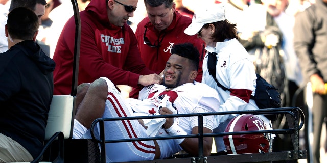 Alabama quarterback Tua Tagovailoa (13) is carted off the field after getting injured in the first half of an NCAA college football game against Mississippi State in Starkville, Miss., Saturday, Nov. 16, 2019. (AP Photo/Rogelio V. Solis)