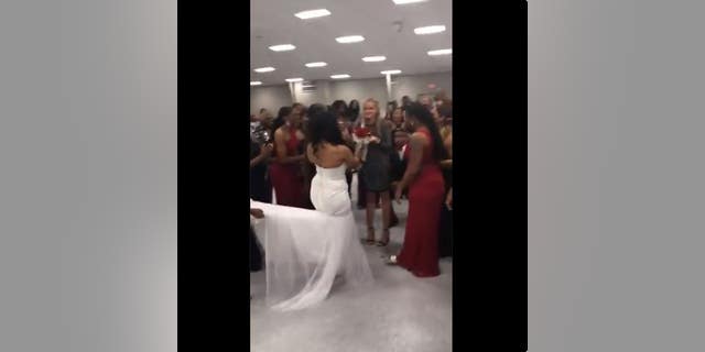 According to Twitter, the bride conspired with her brother for the surprise proposal and came up with the idea to hand the bouquet to his girlfriend.