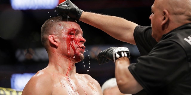 A trainer helps Nate Diaz after the first round of a welterweight mixed martial arts bout against Jorge Masvidal at UFC 244 early Sunday, Nov. 3, 2019, in New York. Masvidal won in the fourth round. (AP Photo/Frank Franklin II)