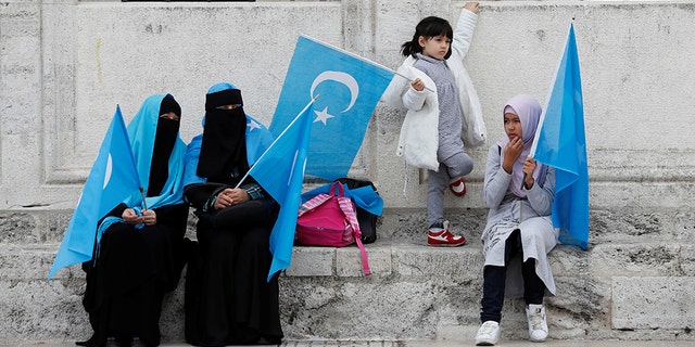 Uighur women hold East Turkestan flags at the courtyard of Fatih Mosque, a common meeting place for pro-Islamist demonstrators, during a protest against China, in Istanbul, Turkey, November 6, 2018. REUTERS/Murad Sezer 