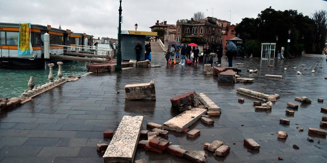 Parts of a dock lie damaged, in Venice, Italy, Wednesday, Nov. 13, 2019.