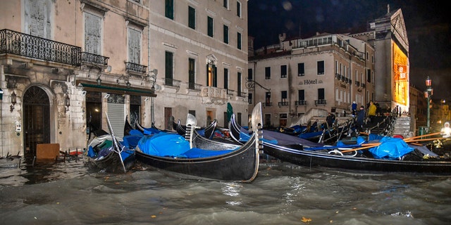 Stranded gondolas float adrift over the flooded banks, in Venice, Wednesday, Nov. 13, 2019.