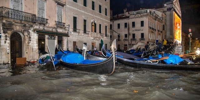Stranded gondolas float adrift over the flooded banks, in Venice, Wednesday, Nov. 13, 2019.