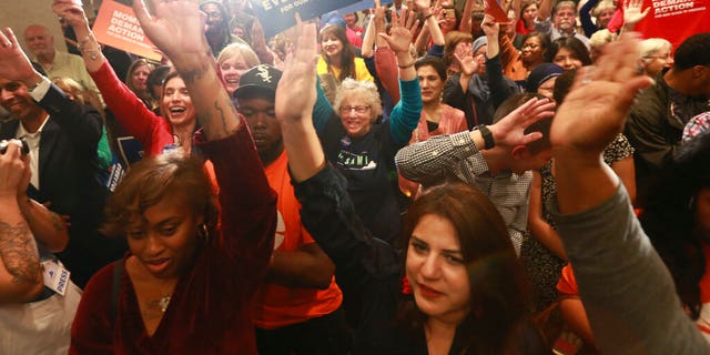 Democratic supporters cheer their candidates at a Democratic Party event in Richmond, Va., Tuesday, Nov. 5, 2019. All seats in the Virginia House of Delegates and state Senate are up for election. (AP Photo/Steve Helber)