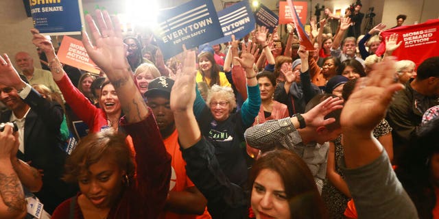 Democratic supporters cheer their candidates at a Democratic Party event in Richmond, Va., Tuesday, Nov. 5, 2019. All seats in the Virginia House of Delegates and state Senate are up for election. (AP Photo/Steve Helber)