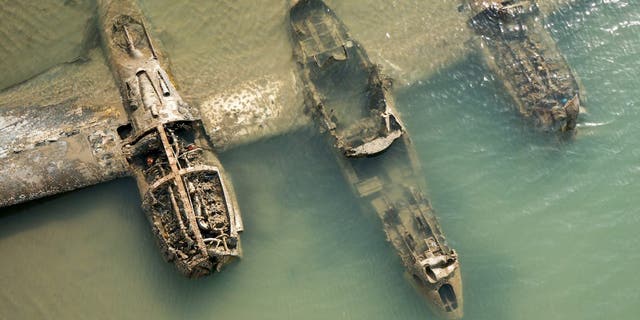 The plane is buried beneath 6.6 feet of sand, but, as here, it sometimes appears from the sands.