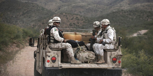 Mexican national guardsmen patrol near Bavispe, at the Sonora-Chihuahua border in Mexico. (AP Photo/Christian Chavez)