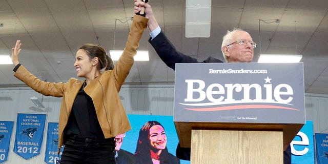 Democratic presidential candidate Sen. Bernie Sanders, I-Vt., and Rep. Alexandria Ocasio-Cortez, D-N.Y., stand on stage on the campus of Iowa Western Community College in Council Bluffs, Iowa, Friday, Nov. 8, 2019. (AP Photo/Nati Harnik)